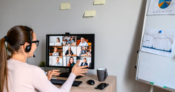 Young woman working with team from home